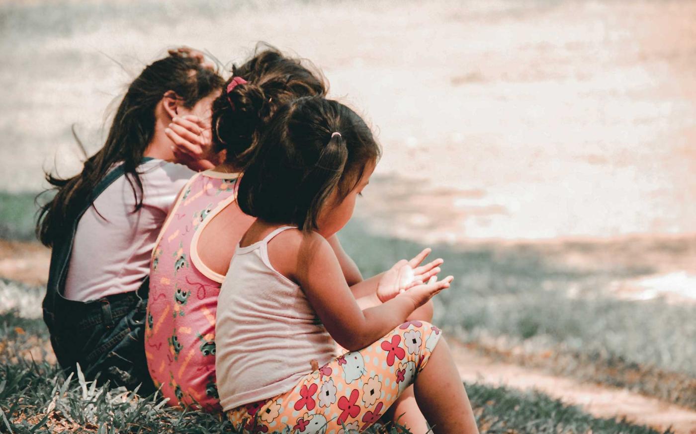 Group of children sitting on bench.